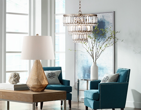 A chandelier and table lamp in a chic room.