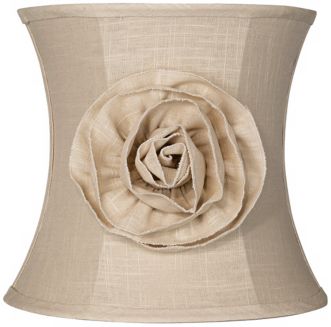 A lamp shade with a fabric flower.