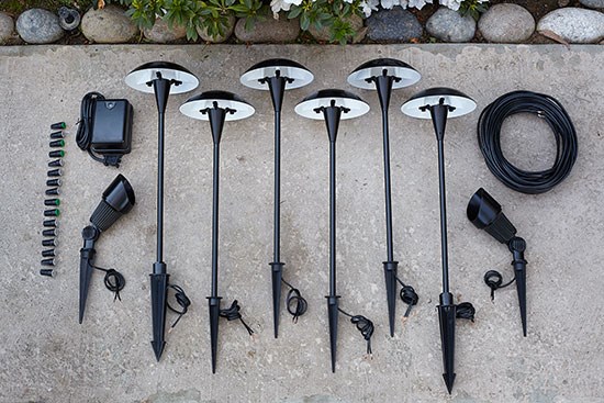 Six landscape lights and the materials needed for installation. 