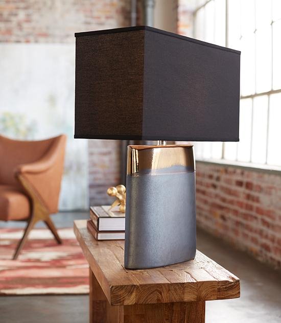 The Moonrise Noir table lamp sits within a modern room.