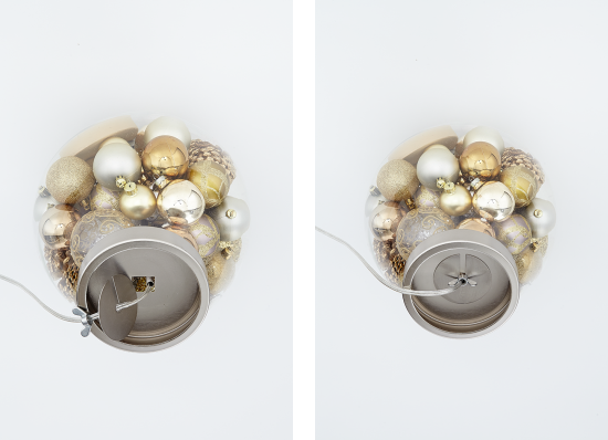 A reassembled table lamp base filled with ornaments. 