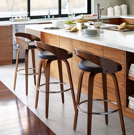 Stools are lined up against a kitchen island.