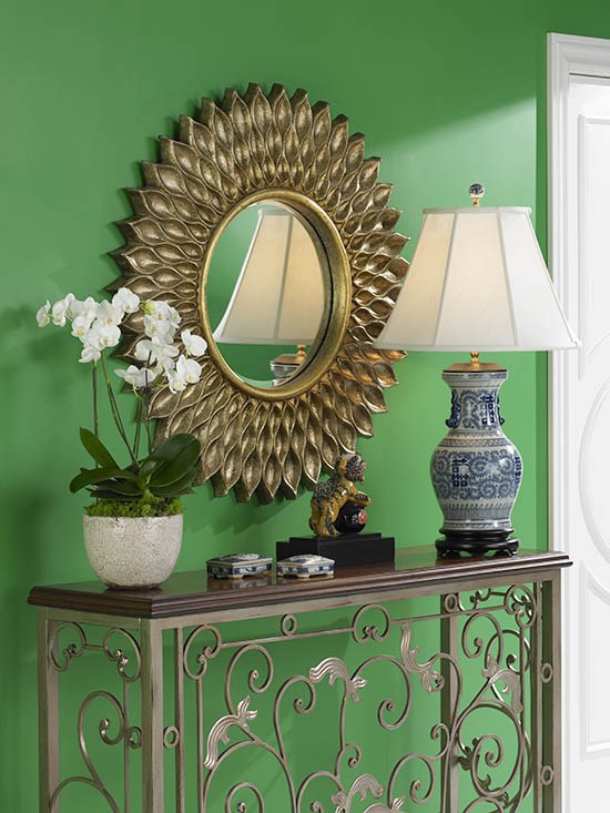 A round mirror with other decor.