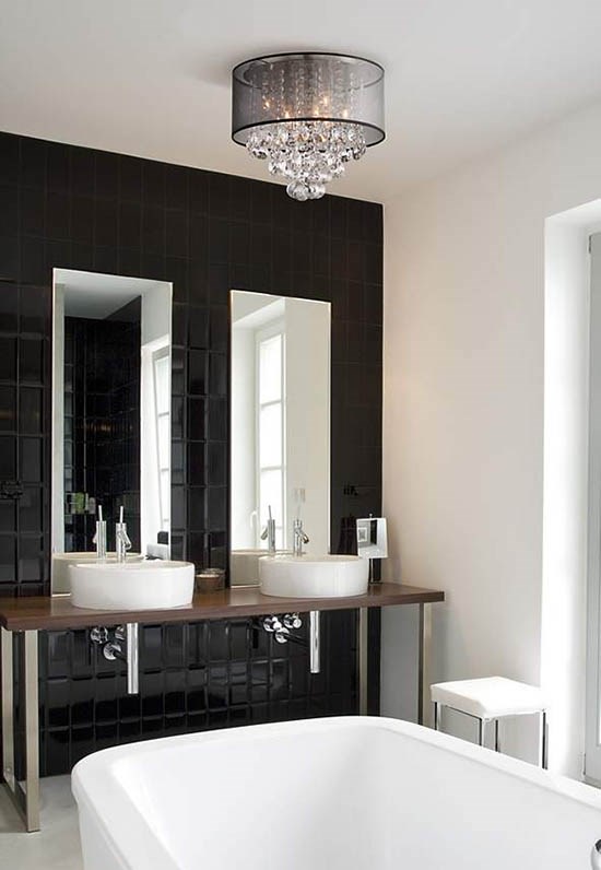 A ceiling light with crystal accents and a drum shade in a bathroom.