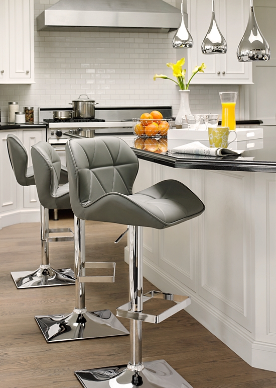 Modern adjustable stools in a dining area.