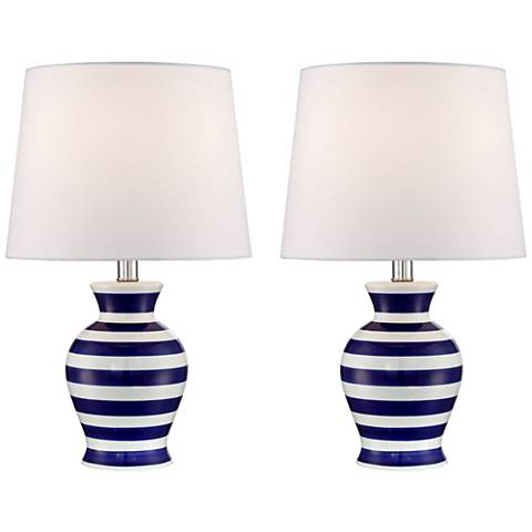 Two blue and white table lamps with white shades. 