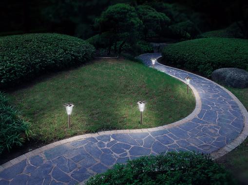 An outdoor path accented by path lights.
