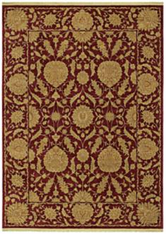 A dark red rug with golden brown decorative elements.