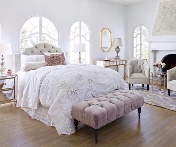 A bedroom setting with side table lamps. 