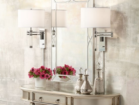 Contemporary style wall lamps next to a mirror.