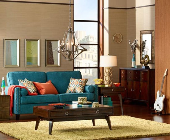 A living room with a table lamps, pendant light, and furniture. 