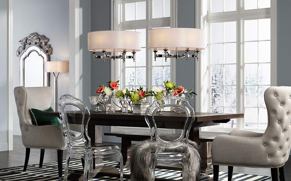 A transitional dining room with two contemporary pendants and a floor lamp