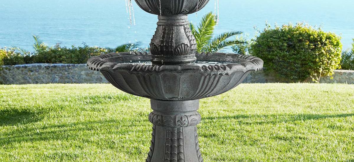 Tiered fountain in a back yard with an ocean view