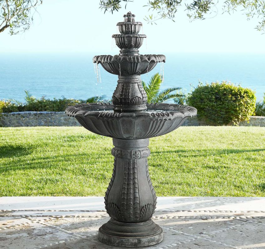 Tiered fountain in a back yard with an ocean view