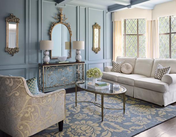 Elegant wall mirrors featured in a blue luxe-style room.