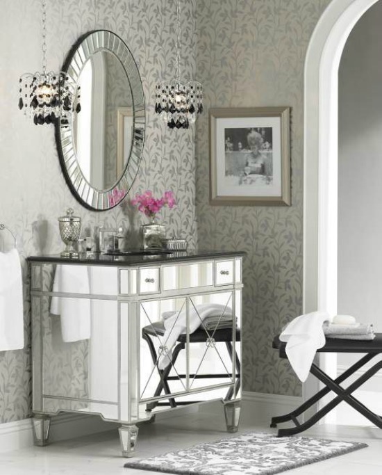 Elegant mirrored sink, with a hanging mirror and crystal pendant lights above. A shining mirrored sink, with a matching mirror and crystal lighting above.