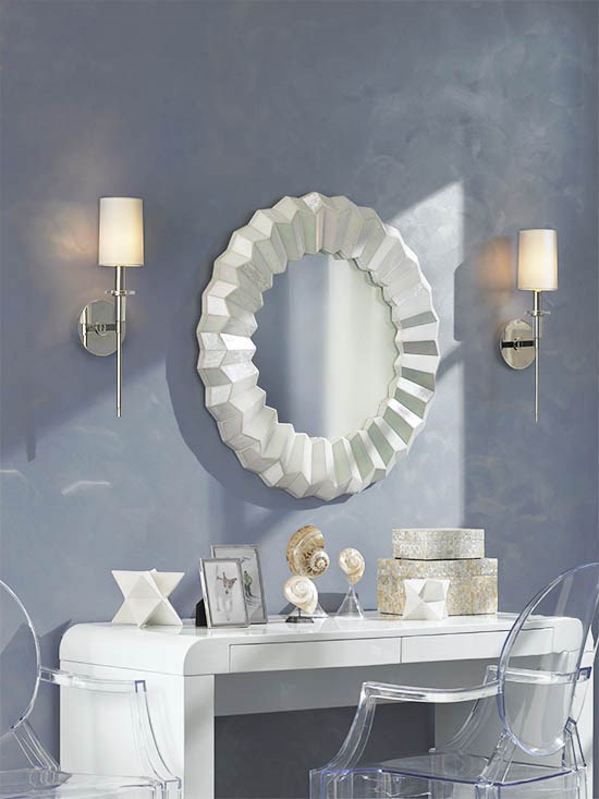 Wall lamps are installed next to a circular modern mirror.
