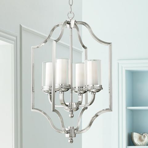 Traditional-style silver finish pendant light holding four white pillar candles. Beautiful silver pendant light in an elaborate traditional style, holding four white candles.