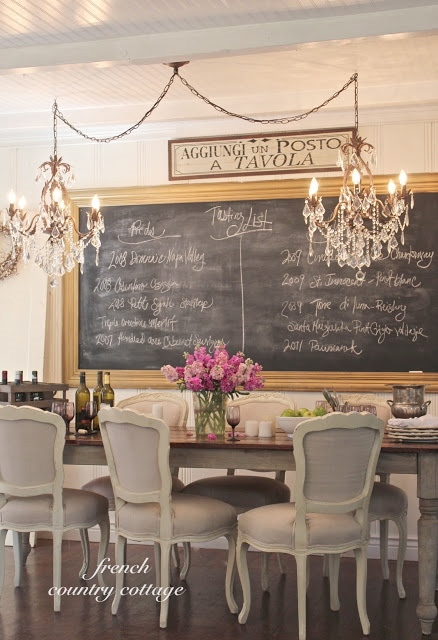 Two smaller chandeliers over a dining room table.