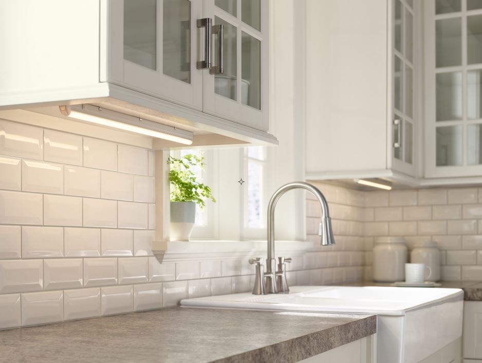 Two light bars under white cabinets in a transitional, elegant kitchen setup.