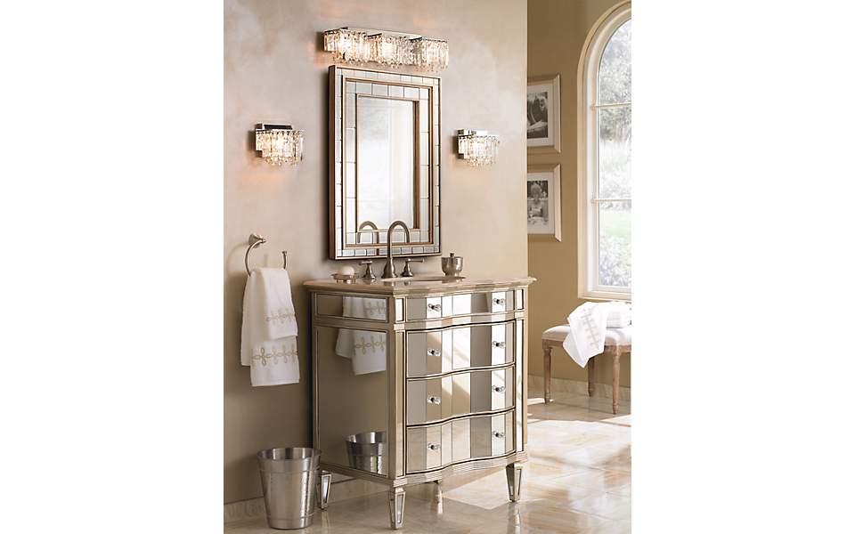 A mirror vanity with bathroom lighting. 