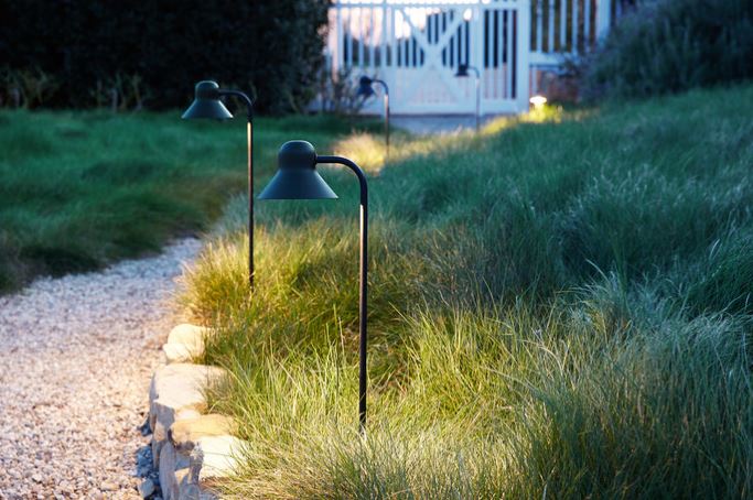 Path lights illuminating a rocky walkway. 