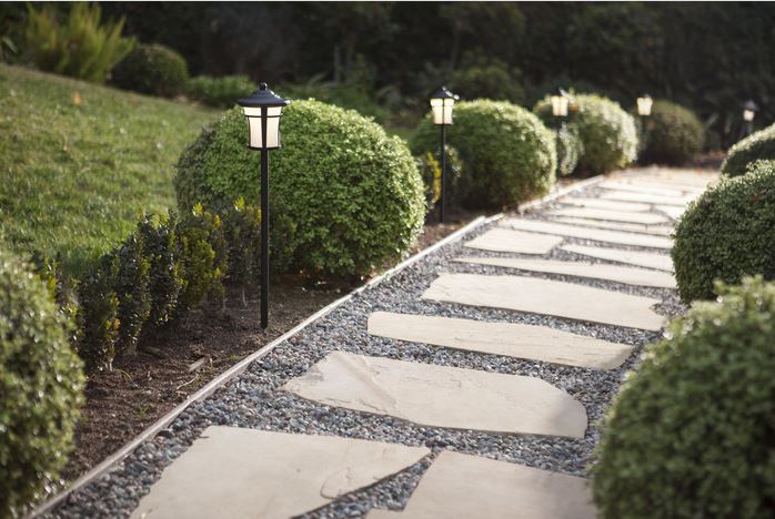 An outdoor walkway with path lights. 