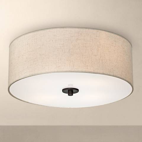 A close up of a flush mount ceiling light. A flush mount ceiling light.