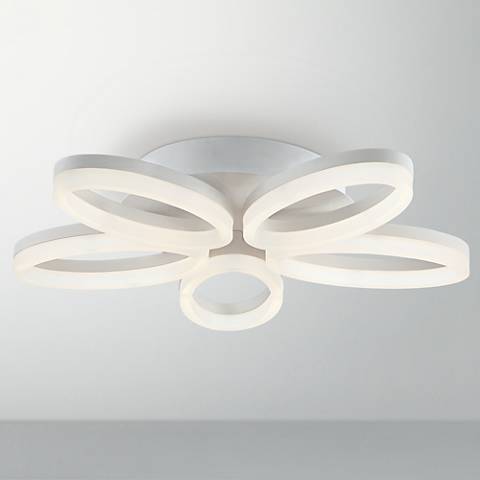 A white close to ceiling light with five petals like a flower. A contemporary white close to ceiling light in a flower shape.