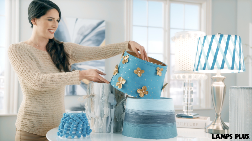 A woman viewing her homemade lamp shades. 