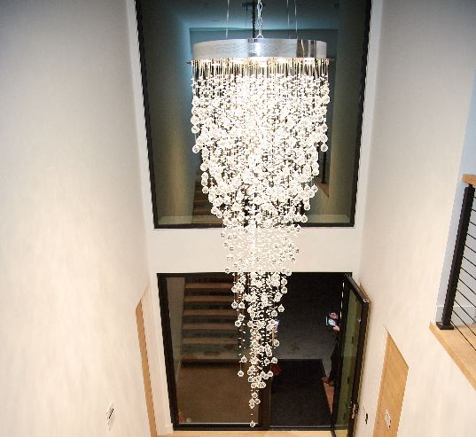 A sparkling crystal chandelier hanging in an entryway.