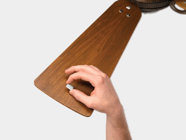 A ceiling fan blade with the permanent balance kit in place